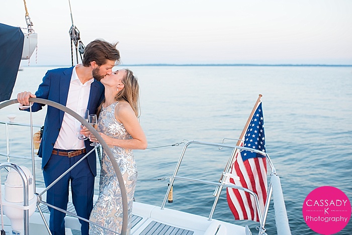 Nautical Engagement Session, Sailboat, American Yacht Club, Rye, New York, NY, Sequin Dress, Navy Suit, Gold, Diamond Ring, Cassady K Photography, Wedding Photographers NYC, Sunset, Sapphires, Pop Champagne, Bubbly, United States Flag, Red, White, Blue, Water, Ocean