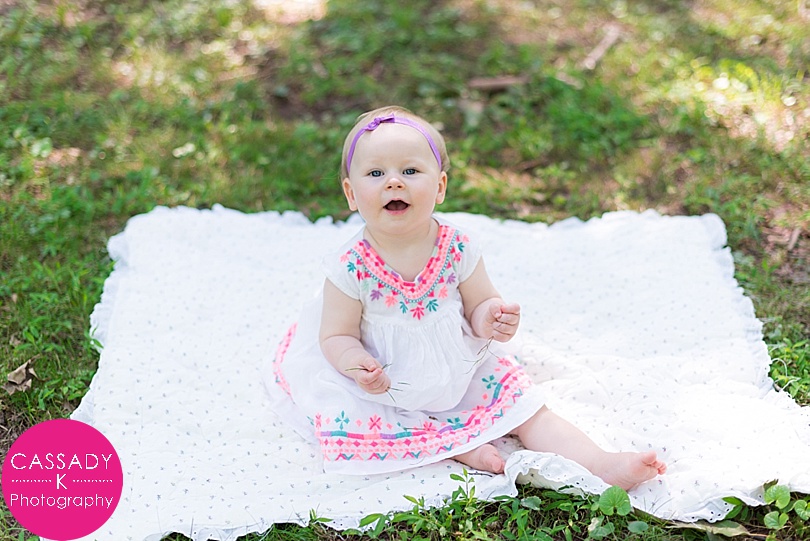 Baby Girl sitting on a blanket outside for One Year Pictures in Landsdale, PA