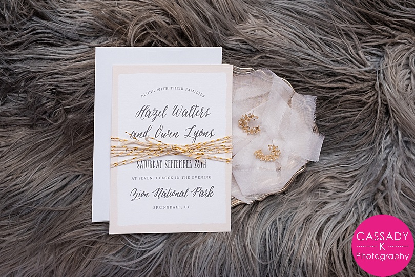 Wedding Invitation styled on fur blanket with gold Anthropologie Earrings for Basic Invite Invitations Styled Shoot