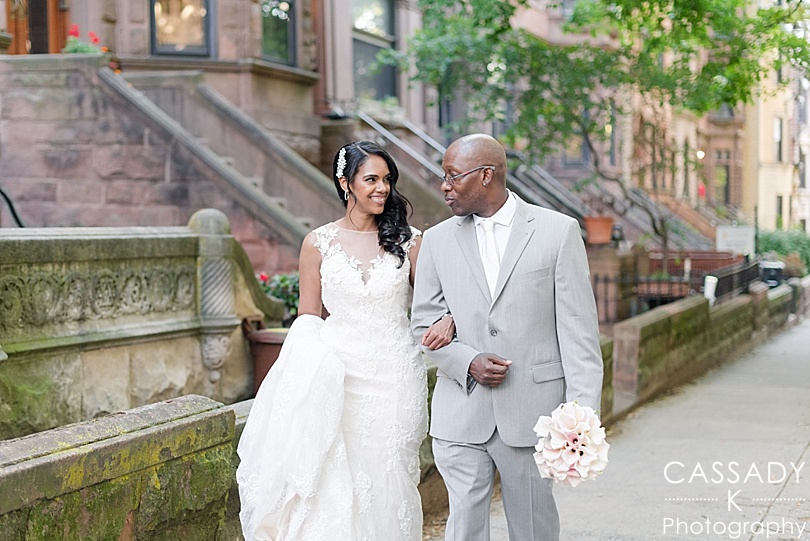 Bride and Groom look at each other while walking through brownstones in Brooklyn during a Frankies 457 Wedding