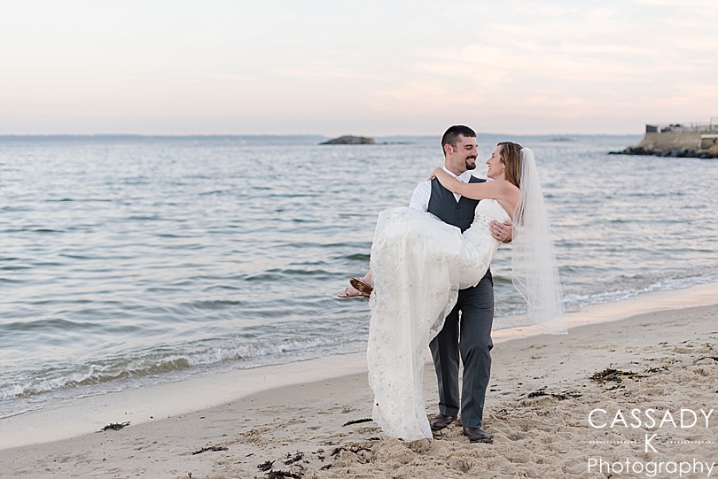 Groom holding Bride on beach during a one year anniversary Rye Beach NY Session