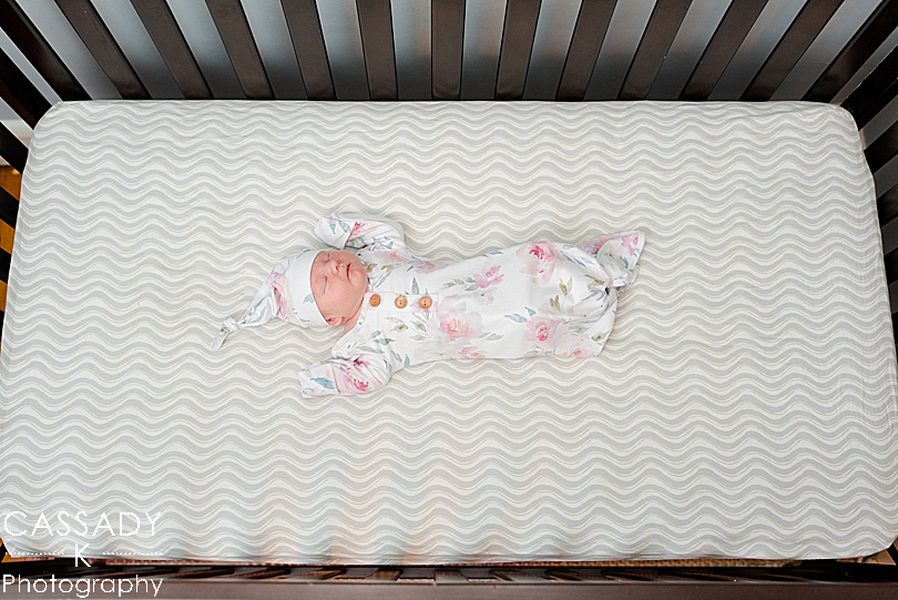 Tiny baby lays in crib during a PA Family Newborn Session at home in Lansdale