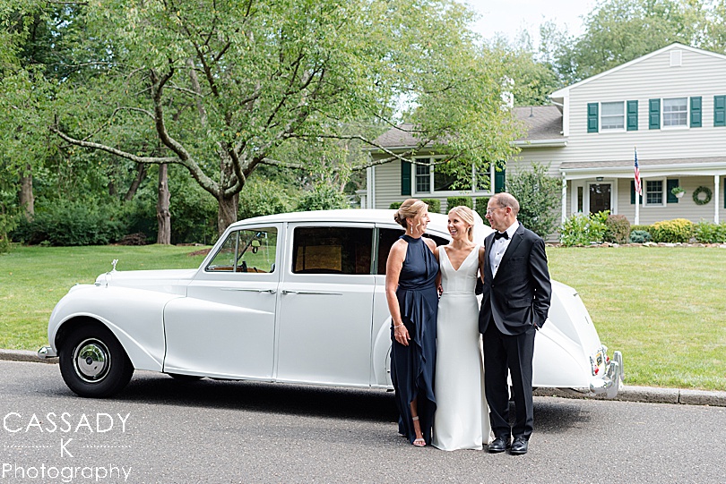 Bride, Father and Mother with a white Rolls Royce before a Small Ninety Acres Wedding in Natirar of Peapack, NJ
