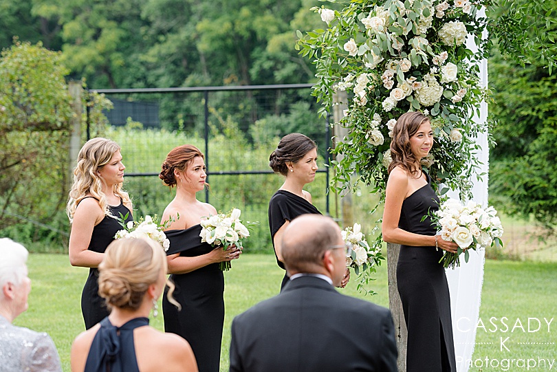 Bridesmaids lined up at an outside ceremony at a Small Ninety Acres Wedding in Natirar of Peapack, NJ