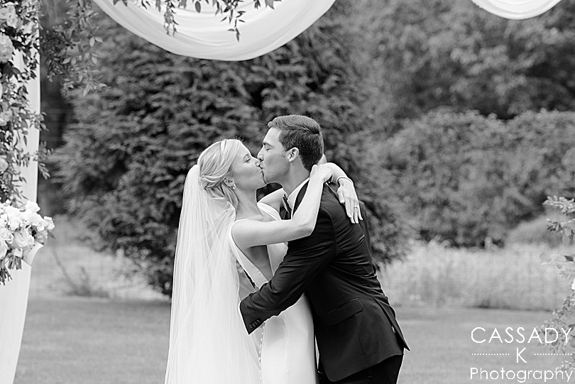 Bride and Groom's first kiss during an outside ceremony at a Small Ninety Acres Wedding in Natirar of Peapack, NJ