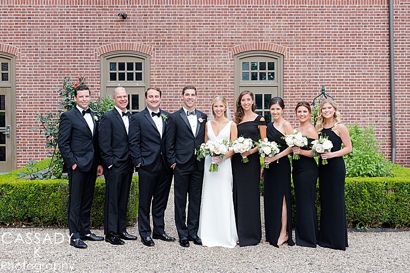 Bridal Party in front of brick building during a Small Ninety Acres Wedding in Natirar of Peapack, NJ