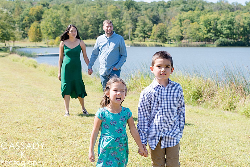 Tips for Family Photos from a family walking around a lake at Green Lane Park doing Fall activities in PA