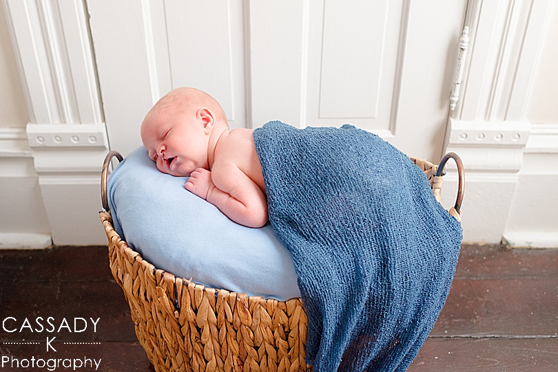 Baby boy with cleft palate asleep in a basket at home Williamsport Newborn Session in PA