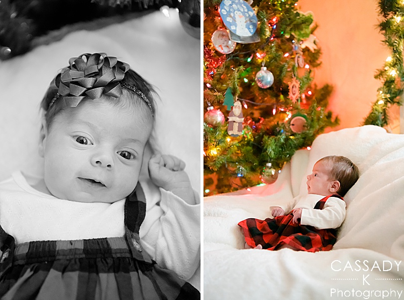 Baby girl memorized by lights on the tree at an at home Pittsburgh newborn session during Christmas time
