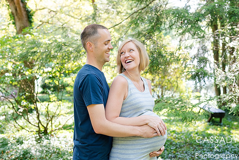 Mom and Dad laugh during a maternity session outside in Williamsport, PA for a 2020 photography review