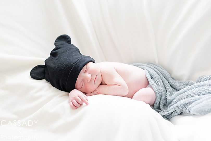 Baby boy with a black Mickey hat on during a newborn session in Pittsburgh, PA for a 2020 photography review