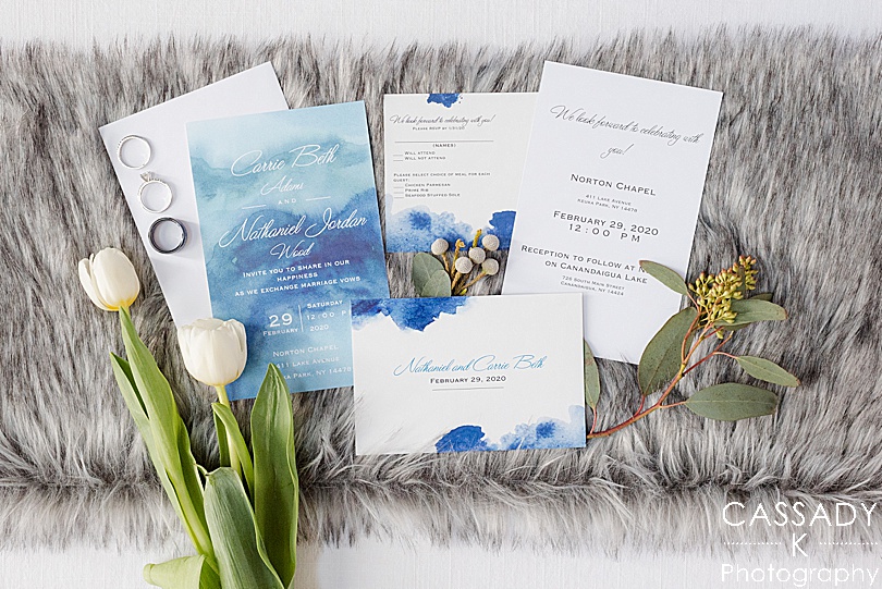Vistaprint blue watercolor wedding invitation suite with white tulips and rings on a gray fur for the 2020 photography review