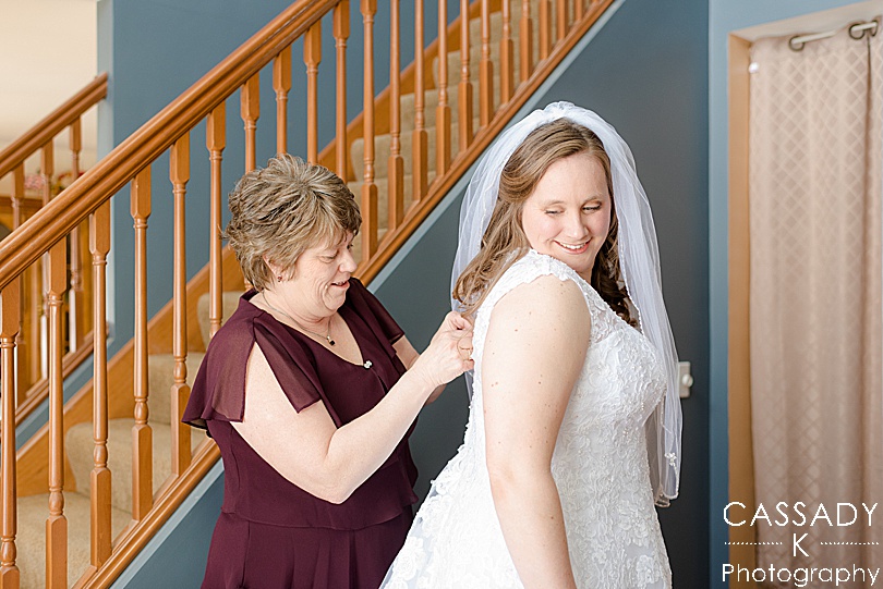 Mother helps her daughter into her wedding dress in upstate, NY for the 2020 photography review