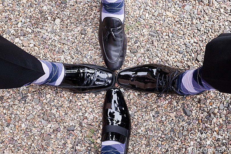 Groomsmen wear matching purple argyle socks at a small outside Ninety Acres wedding during a 2020 photography review