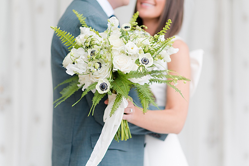 Bride and Groom with white and green bouquet at DeLaMar Southport during a spring Tokeneke Club Wedding in Darien, CT