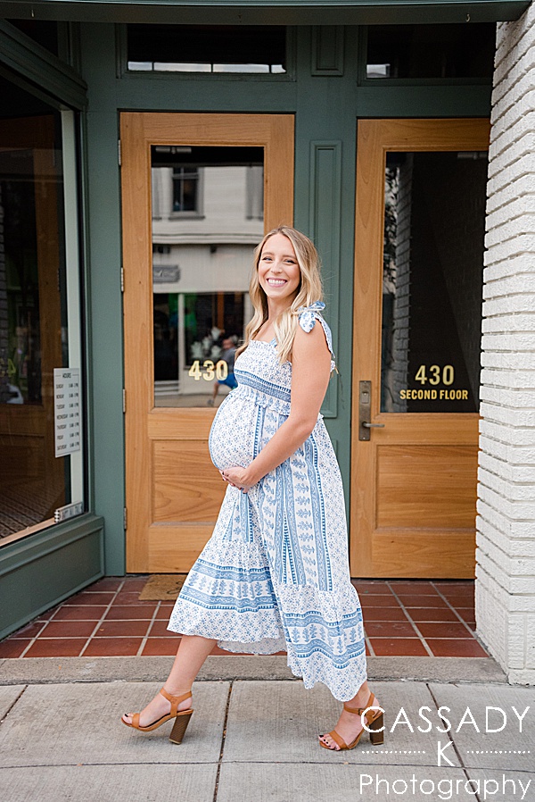 Pregnant mom walks through the small town during a Sewickley maternity session for her baby girl in Pittsburgh, PA by Cassady K Photography