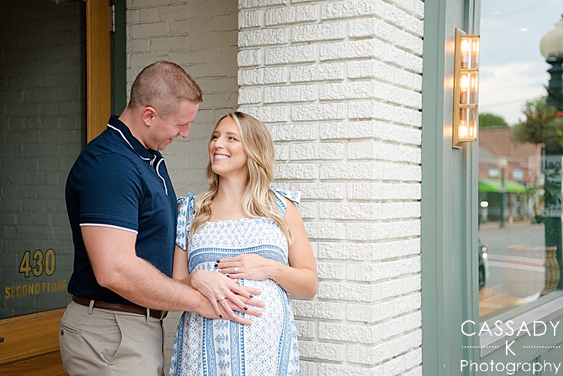 Parents look at each other while they are expecting their baby girl during a Sewickley maternity session by a Pittsburgh Family Photographer