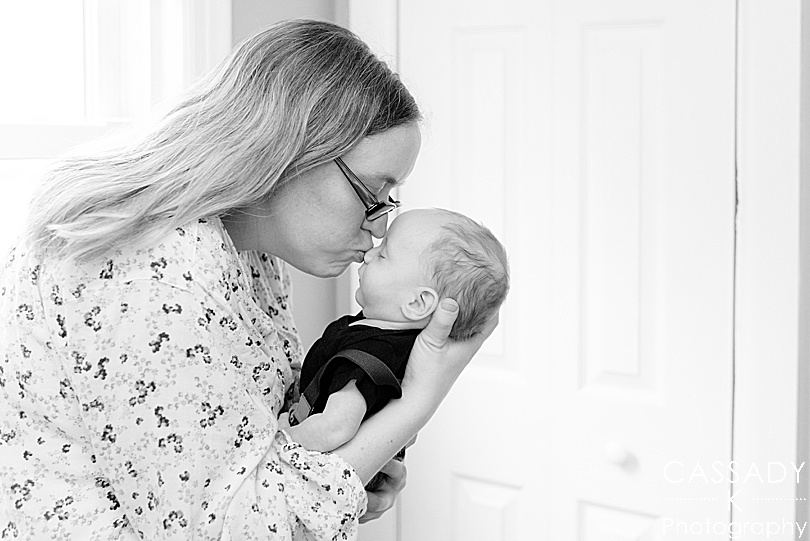 New mother kissing son during Bellefonte Home Newborn Pictures with family photographer Cassady K Photography in PA