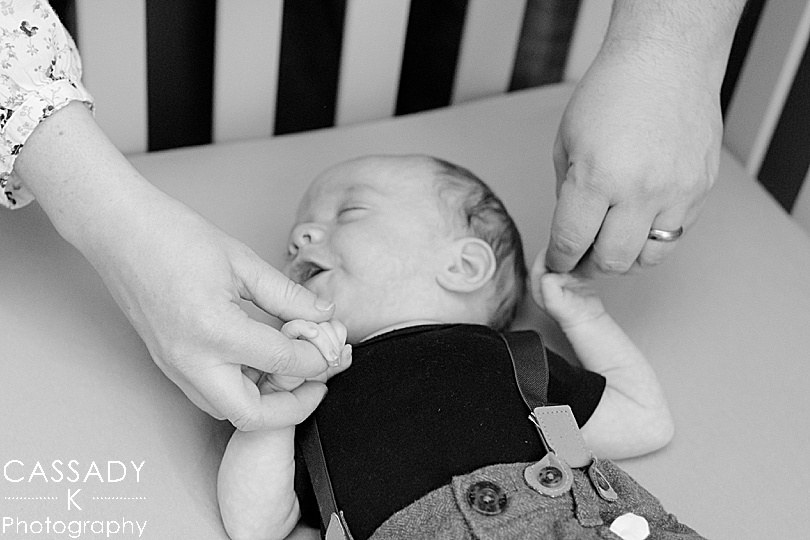 Parent's hold son's tiny hands during Bellefonte Home Newborn Pictures in Centre County, PA