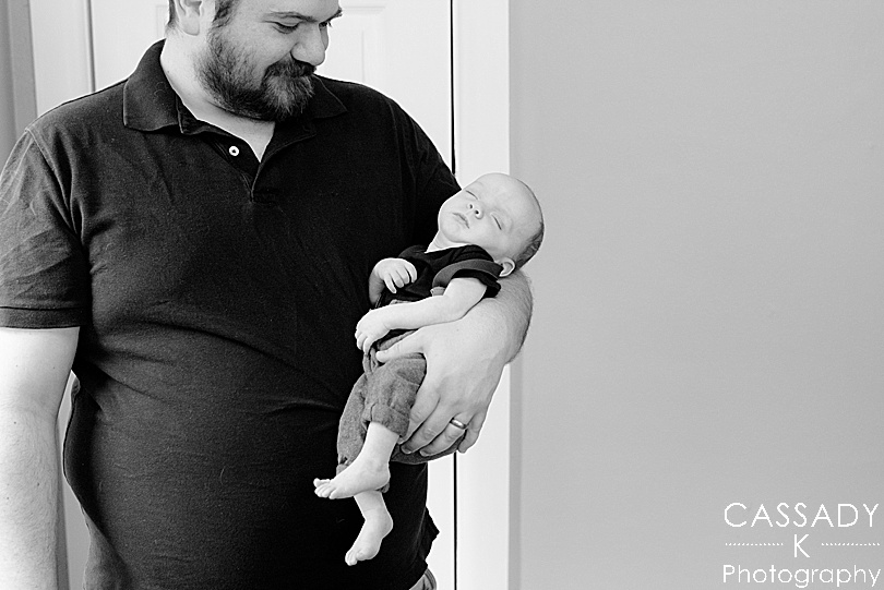 New father holding son during Bellefonte Home Newborn Pictures with family photographer Cassady K Photography in PA