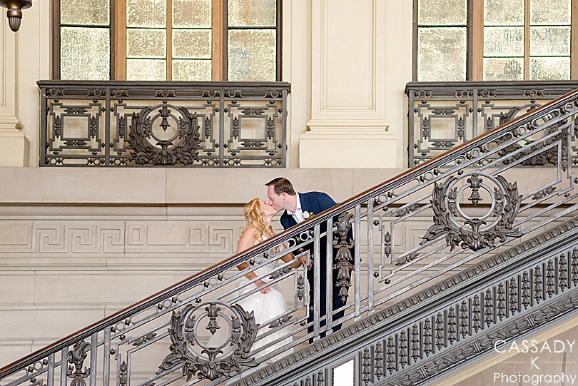 Bride and groom kissing on stairs in Hoboken Terminal during their New Jersey Wedding