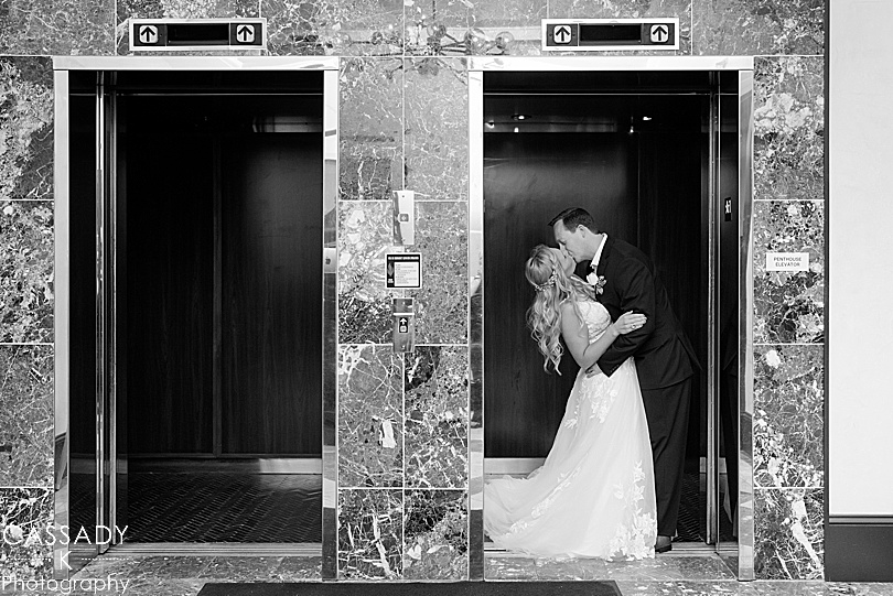 Black and white of bride and groom in elevator kissing at Antique Loft in Hoboken, NJ