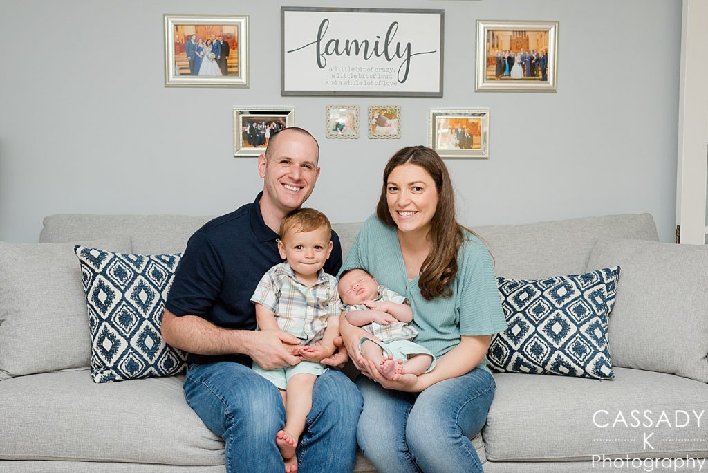 Family in home on couch during newborn picture session in Bedford NY Westchester county