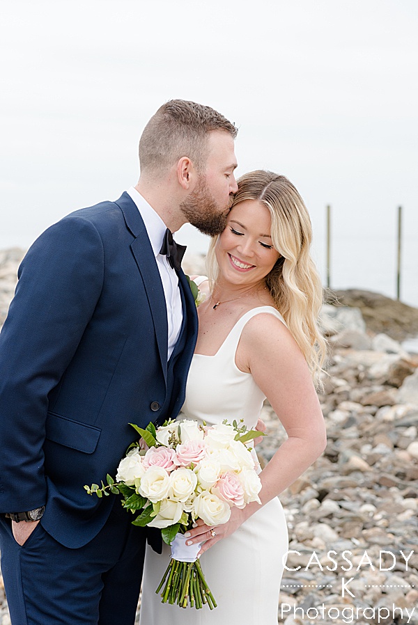 Close up image of bride and groom on rock jetty at Spring Tokeneke Club Wedding