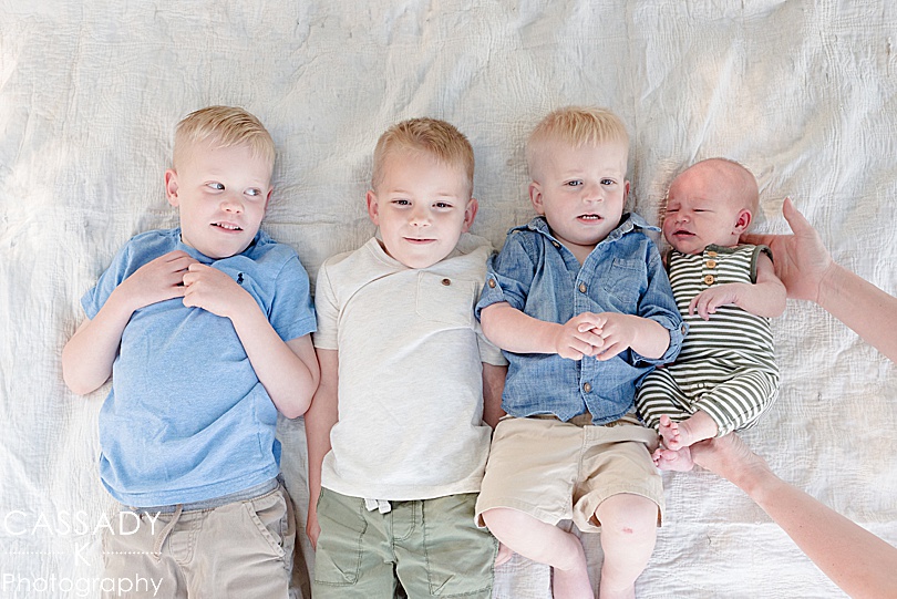 Four boys in an outside family newborn session