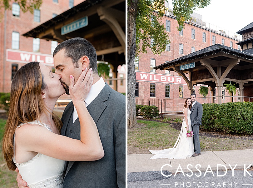 Husband and wife kissing in front of Lititz train station