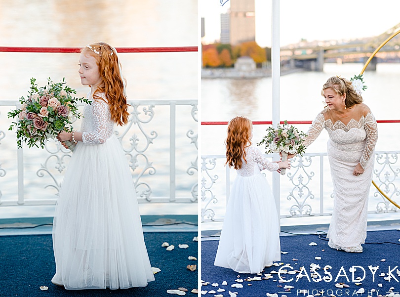 Flower girl handing flowers to bride at fall Gateway Clipper wedding in Pittsburgh