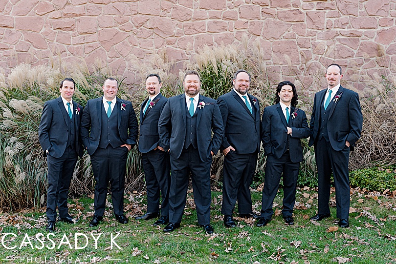 Groomsmen standing in front of stone wall at Mount Hope Estate Wedding