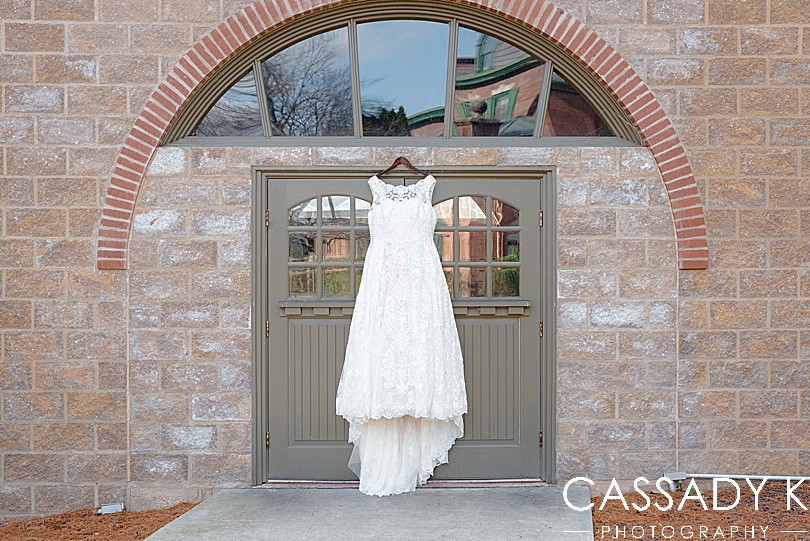 David's Bridal wedding dress hanging in front of door for Mount Hope Estate Wedding