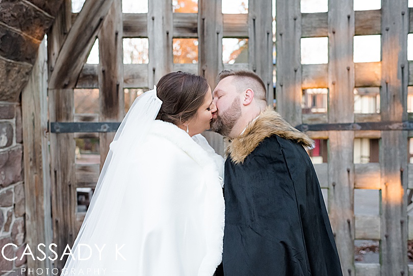Bride and groom kissing in front of gate at Mount Hope Estate Wedding
