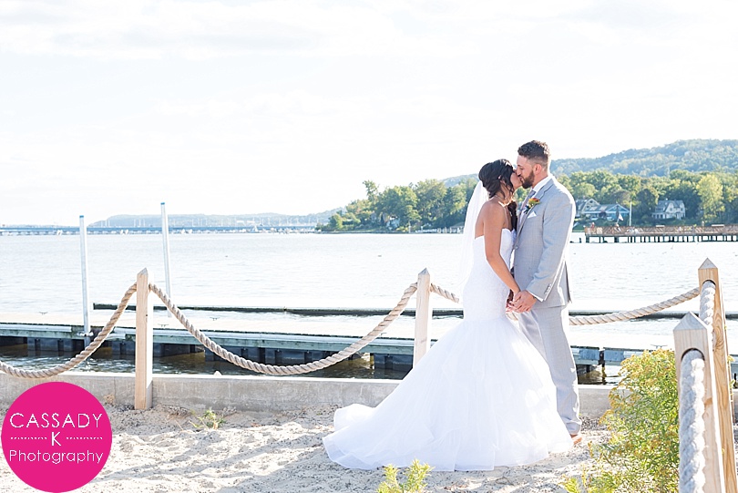 Bride and Groom kissing on dock along Hudson River during a Nyack Seaport Wedding