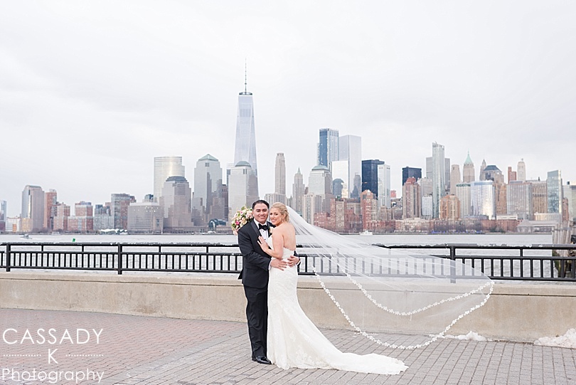 Bride and Groom in Jersey City with the NYC skyline behind them during their Liberty House Restaurant Wedding