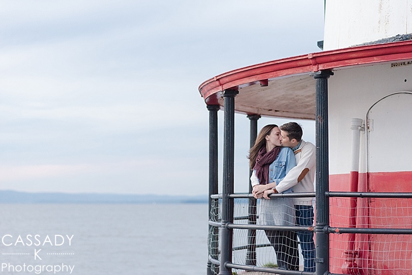 Engaged Couple kissing on the edge of a lighthouse during a Sleepy Hollow Lighthouse Engagement Session in Westchester County, NY