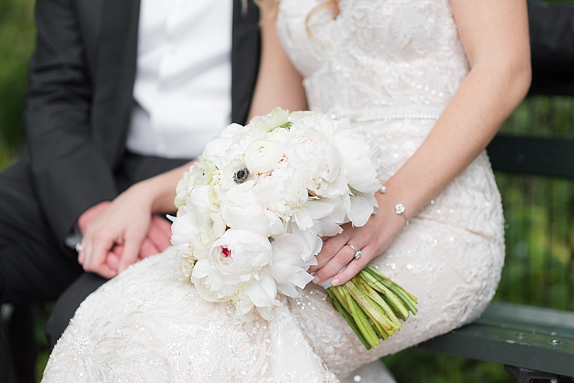 Bride holding white bridal bouquet while holding groom's hand in Central Park during a Park Hyatt New York Wedding