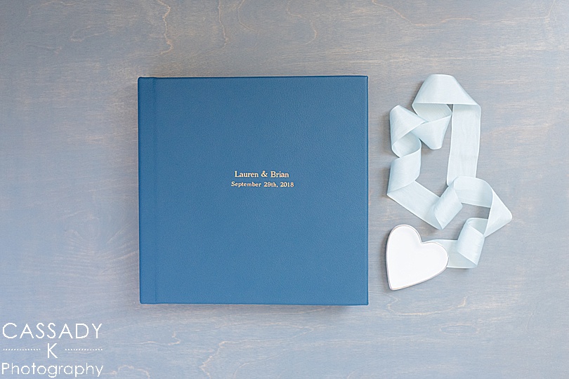 Blue leather album with rose gold imprinting from a Dutchess Manor Wedding Album from Leather Craftsmen