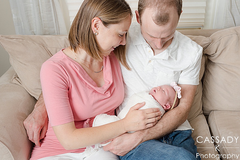 Mom and Dad hold baby girl during a PA Family Newborn Session at home in Lansdale