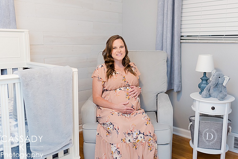 Pregnant mom sits in a gray and blue baby boy nursery during a Pittsburgh Maternity Session