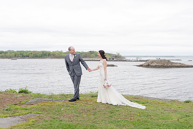 Bride and Groom walk along the water before their Jewish Spring Glen Island Wedding in New Rochelle, NY in early May