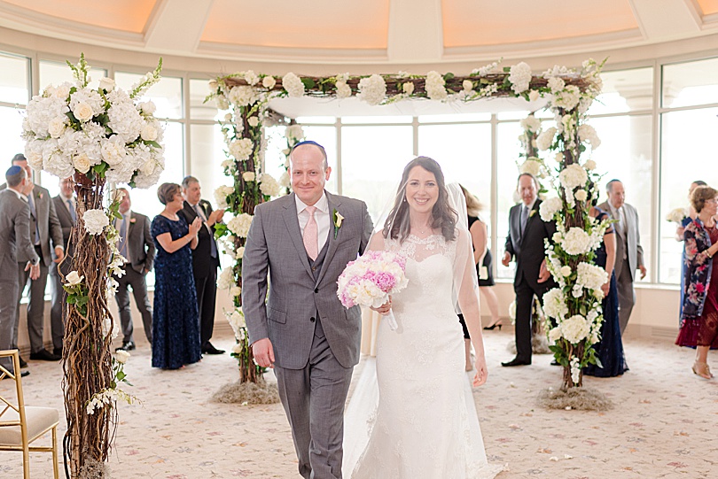 Couple walks back down aisle after getting married during a Spring Glen Island Wedding Jewish Ceremony in New Rochelle