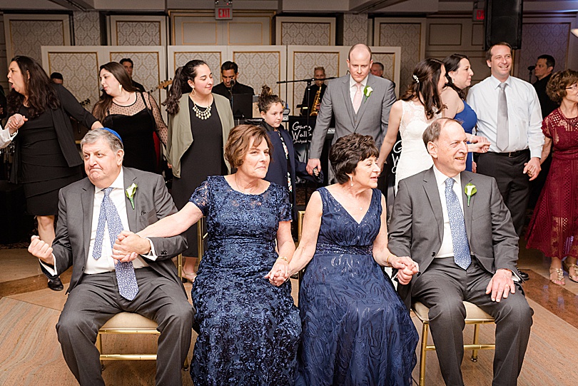The Mezinke dance where guests dance around the parents during a Spring Glen Island Wedding Jewish Reception in New Rochelle