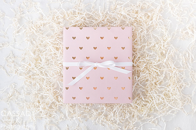 A box wrapped in light pink paper for the Erin Condren Holiday Instagram Giveaway by Cassady K Photography