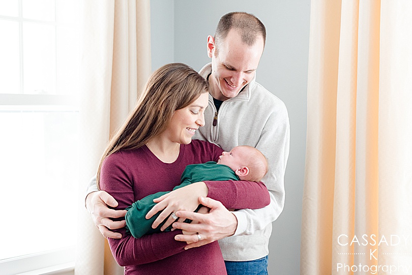 Brand new mom and dad hold their baby boy during an at home Bedford newborn session in Westchester County, NY