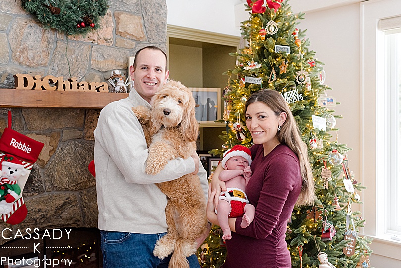 Family Christmas picture with a baby boy and a Labradoodle during an at home Bedford newborn session in Hudson Valley, NY