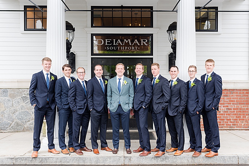 Groom in a checkered jacket and navy groomsmen suits for a spring Tokeneke Club Wedding in Darien, CT