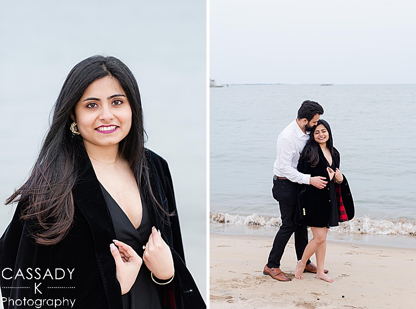 Groom shares his black velvet suit jacket with his new fiancée on the waterfront during a Madison Beach engagement proposal the spring