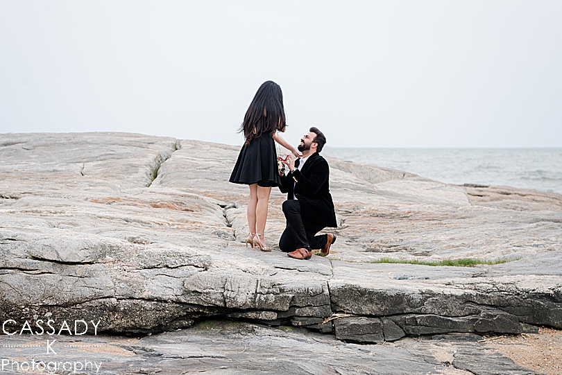 Bride says yes to groom proposing by the water during a Madison Beach engagement proposal